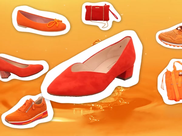 Vorschaubild von Schuh-Neumann: Rote und orangefarbene Schuhe auf orangefarbenem Hintergrund.